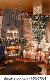 alternative tree upside down on the ceiling. Winter home decor. Modern loft interior with fireplace and brick wall