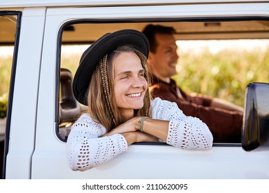 alternative waderlust vacation concept outdoor, couple enjoy the road together, travel. beautiful man and woman in camper van, in complete freedom, feel happiness. Side view. People lifestyle
