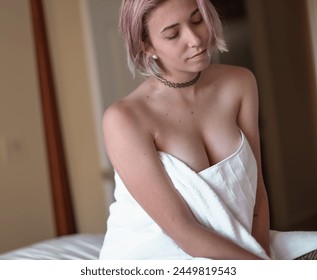Alternative Woman Sitting on Bed in a White Towel