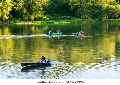 Althom, Pennsylvania, USA 8/10/2019 A Boat And Kayaks On The Allegheny River In Warren County On A Summer Day