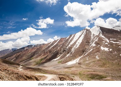 Altitude Road And Snowy Rock Mountain Rage In Summer