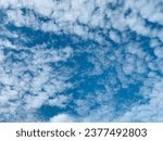 Altocumulus clouds are full of beautiful streaks. The weather is fine, with winds often appearing between the lower stratus and higher cirrus clouds at Bangkok, Thailand. no focus