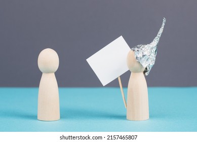 Alu Hats Protester Talking To A Person, Conspiracy Theories, Tin Foil On The Head, Holding An Empty Sign, Conversation And Communication Concept