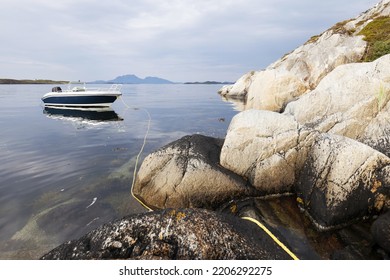 Aluminium Boat Tied To Rocks On A Still Day At Norwegian Coast