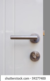 Aluminium Door Knob On The White Door