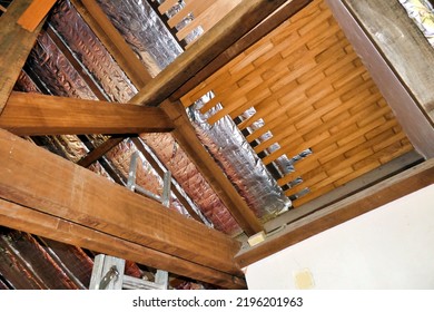 Aluminium foil roof insulation exposed in a vaulted ceiling after wood panelling removed
 - Shutterstock ID 2196201963