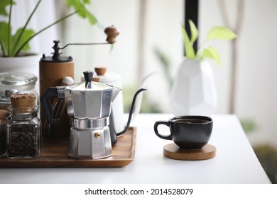 Aluminium moka pot and black coffee cup with coffee stuffs - Powered by Shutterstock