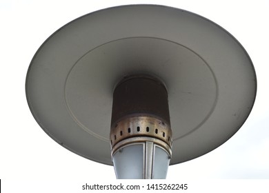 An Aluminium Patio Heater In A Garden. 