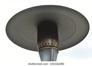 An Aluminium Patio Heater In A Garden. 