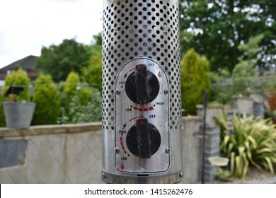 An Aluminium Patio Heater In A Garden. 