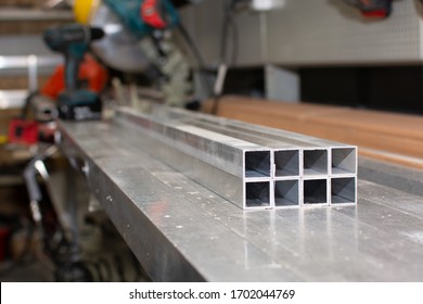 Aluminium profile for manufacturing. Structural metal aluminium shapes. Aluminium profiles texture for constructions. Aluminum profile is on the desktop for further work.
