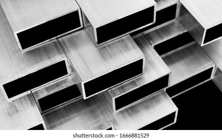 Aluminium profile for windows and doors manufacturing. Structural metal aluminium shapes. Aluminium profiles texture. Aluminium constructions background. Black and white