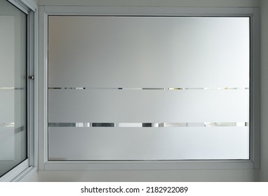 Aluminium sliding window of office. office sliding glass window. Decorative Glass Film on door of office. Closeup Frosted Glass Thick Film for reduced visibility across. - Shutterstock ID 2182922089