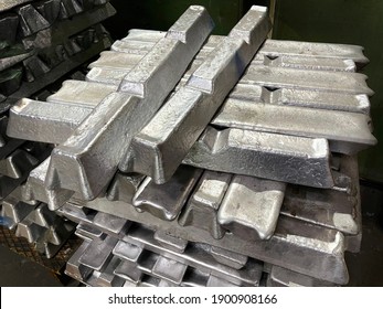 Aluminum Alloy Ingots Stacked In The Foreground, Ready For Casting, Raw Material