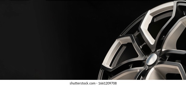 aluminum alloy wheel. Premium cast, the design of the spokes and the wheel rim, a white and black elements on dark background close-up. long layout, copyspace - Shutterstock ID 1661209708
