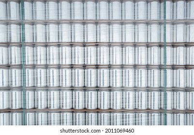 Aluminum Beer Cans Background. New Metal Containers For Cold Beverages Stacked In Supermarket Warehouse