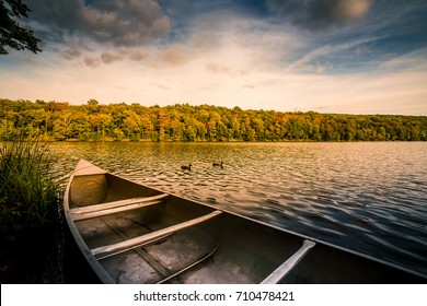 Aluminum canoe on a mountain lake upstate New York. Camping. outdoors and adventure concept.  Faded, vintage color post processed - Powered by Shutterstock