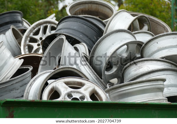 Aluminum car rims thrown into a container for\
recycling, Godshorn, Hanover\
district.