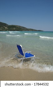 Aluminum chair in water on a beach