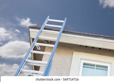 Aluminum Construction Ladder Leaning Against House.