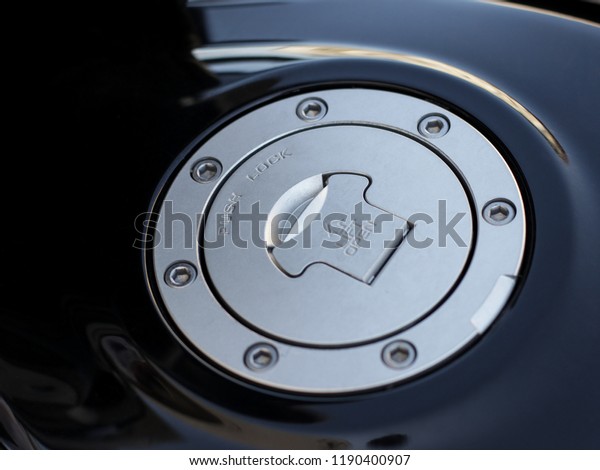aluminum cover of a
black motorcycle gas
tank