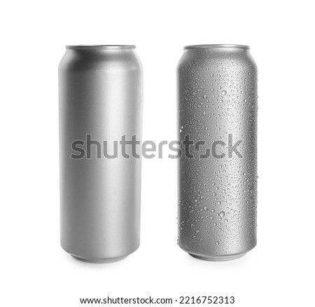 Aluminum drink cans, one with water drops on white background