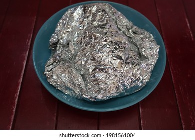 Aluminum Foil And Bowl On Table