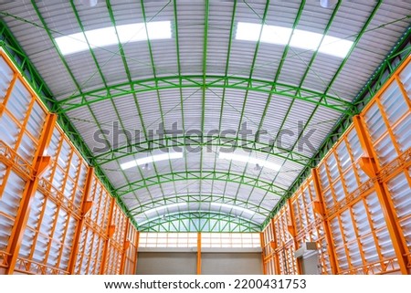 Aluminum Louver Wall with metal Roof Structure inside of large modern Industrial Building, symmetry and low angle view