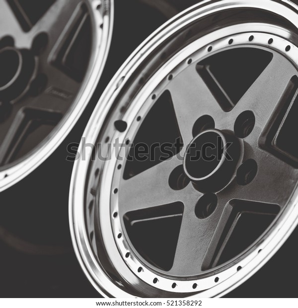 Aluminum metal wheel rim texture. Car alloy\
wheel, isolated on black\
background.