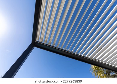 Aluminum pergola for outdoor patio against clear blue sky. Bottom view - Shutterstock ID 2279263839