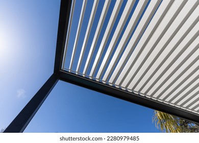 Aluminum pergola for outdoor patio against clear blue sky. Bottom view - Shutterstock ID 2280979485