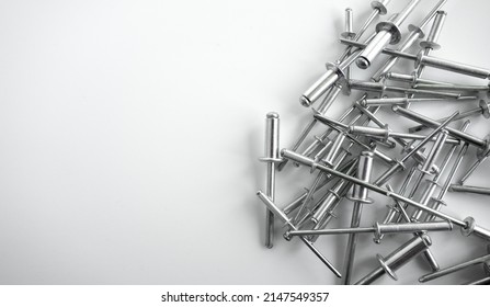 Aluminum rivets on a white background. Sale of rivets and fixing tools.