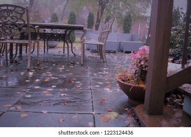 Aluminum Set Of Outdoor Table And Chairs In The Patio Covered With Yellow Leaves 