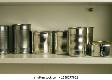 Aluminum Tin Cans Stocked In A Food Cupboard Shelf