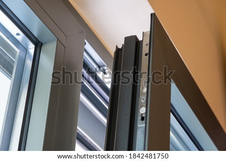 Aluminum window detail. Metal door frame open closeup view. Energy efficient, safety profile, blur background