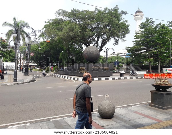Alun-alun bandung, west java,\
indonesia, august 2, 2022. A man walks on the sidewalk in Bandung\
square