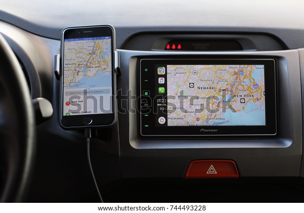 Alushta,\
Russia - April 20, 2017: iPhone with Apple Maps on the screen and\
Car Play on the multimedia system. iPhone, Apple Maps and Car Play\
was created and developed by the Apple\
inc.