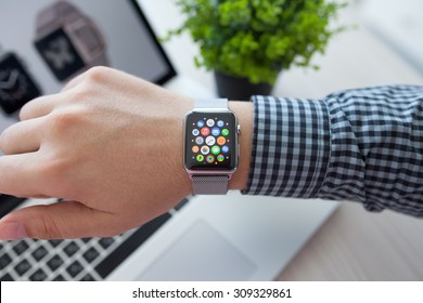 Alushta, Russia - August 14, 2015: Man hand with Apple Watch and app Icon on the screen. Apple Watch was created and developed by the Apple inc