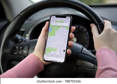 Alushta, Russia - December 16, 2017: Woman Hand Holding IPhone X With Navigation Map On The Screen In The Car. IPhone 10 Was Created And Developed By The Apple Inc.