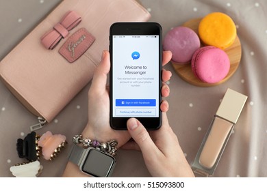 Alushta, Russia - November 11, 2016: Woman Hand With Apple Watch Holding IPhone 7 Jet Black With Social Networking Service Facebook Messenger On The Screen.