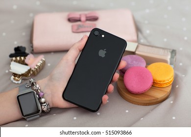 Alushta, Russia - November 11, 2016: Woman Hand With Apple Watch Holding IPhone 7. IPhone 7 Jet Black And Apple Watch Was Created And Developed By The Apple Inc.