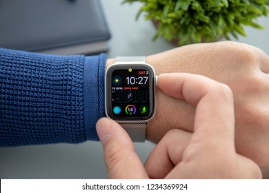 Alushta, Russia - November 3, 2018: Man hand with Apple Watch Series 4 over the table. Apple Watch was created and developed by the Apple inc.