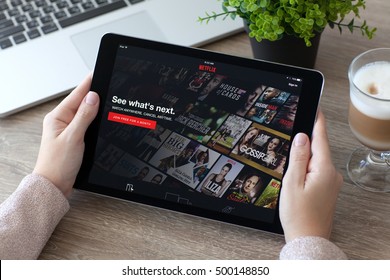 Alushta, Russia - October 9, 2016: Woman Holding IPad Pro With Entertainment Company Netflix Provides Streaming Media And Video On The Screen. IPad Pro 9.7 Was Created And Developed By The Apple Inc.