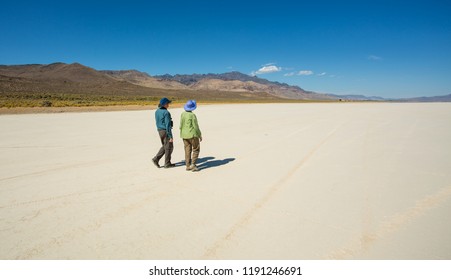 Alvord desert, Oregon - 9/20/2018:  Two tourists walking on the Alvord desert, located just east of the Steens mountains in south central Oregon.