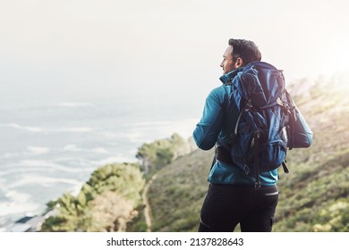 Always Dare To Explore The Beautys Nature Holds. Rearview Shot Of A Middle Aged Man Hiking In The Mountains.