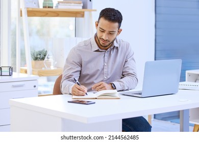 I always find what I need online. Shot of a businessman making notes while sitting at his desk.