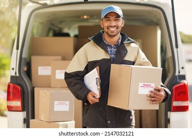 I always get deliveries out on time. Portrait of a smiling delivery man standing in front of his van holding a package. - Powered by Shutterstock