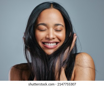  always give hair all the nutrients it needs. Studio shot of an attractive young woman posing against a grey background. - Powered by Shutterstock