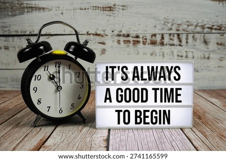 It's Always a Good Time to Begin text with alarm clock on wooden background