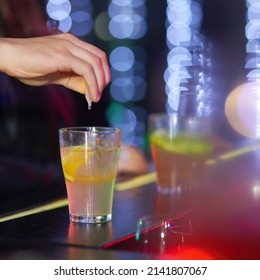 Always keep you eyes on your drink. Closeup shot of a man drungs into a drink in a nightclub.